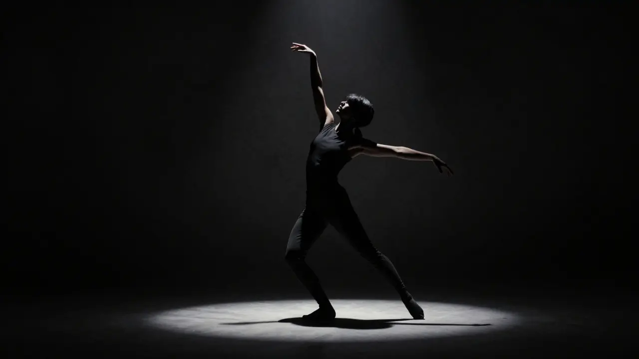Silhouette of a performer standing in a spotlight in a dark room.